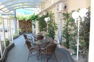 a patio with tables and chairs in a building at Skalla Hotel Nova Odessa in Nova Odessa