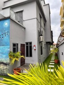 a white building with plants in front of it at NO 5 Hotel in Lekki