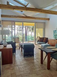 a living room with a couch and a table at Quinta das Eirinhas-Jardim de Bonsai in Tavira +22 photos
