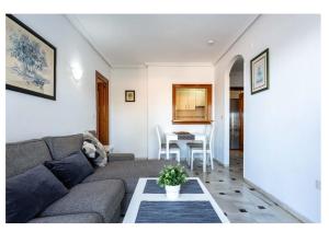a living room with a couch and a table at Urb. Lubina Sol in Mijas Costa