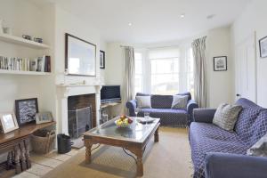 a living room with blue couches and a fireplace at 3 Bed in Southwold oc-aacait in Southwold