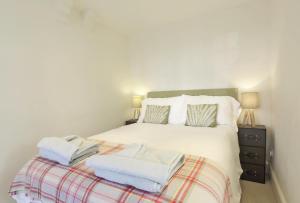 a bedroom with a bed with towels on it at 3 Bed in Southwold oc-aacait in Southwold