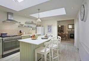 a kitchen with a large island with white counter tops at 3 Bed in Southwold oc-aacait in Southwold