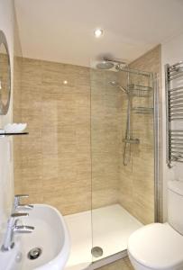 a bathroom with a shower and a sink and a toilet at 3 Bed in Southwold oc-aacait in Southwold +9 photos