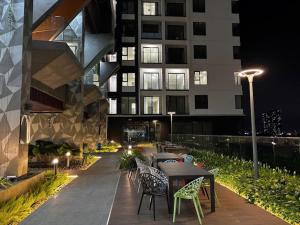 a patio with tables and chairs in front of a building at Youyi Home in Thuan An