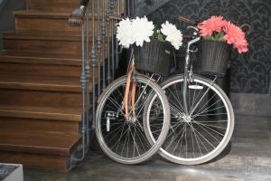 a bike with flowers in baskets is parked next to stairs at Petit Palace Plaza España in Madrid