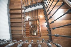 a spiral staircase in a building with wooden floors at Petit Palace Plaza España in Madrid