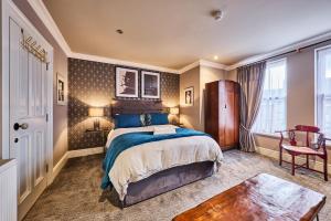 a bedroom with a bed and a table at Art House in Derry Londonderry