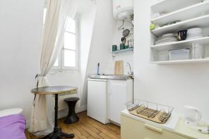 a kitchen with a sink and a table in a room at CHAMPS ELYSEES STUDENT STUDIo in Rosières-près-Troyes +22 photos