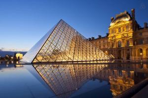 a large glass pyramid in front of a building at CHAMPS ELYSEES STUDENT STUDIo in Rosières-près-Troyes
