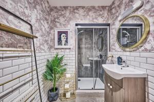 a bathroom with a sink and a shower at Art House in Derry Londonderry +40 photos