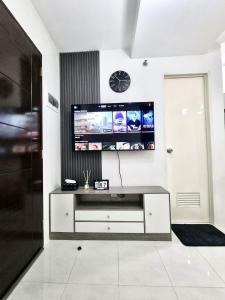 a living room with a tv on a wall at 2BR Staycation in Deca Banilad by XTine City Scape in Banilad