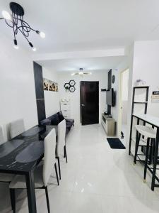 a dining room and living room with a table and chairs at 2BR Staycation in Deca Banilad by XTine City Scape in Banilad