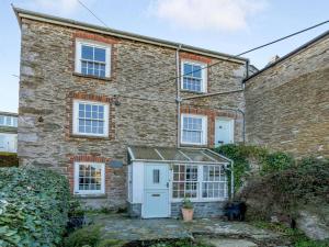 an old brick house with a white door and windows at 2 Bed in Polruan oc-pc033 in Fowey +12 photos
