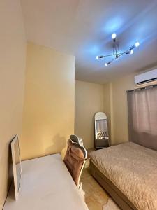 a bedroom with a bed and a mirror in it at Luxy Stay Gensan in Lagao II
