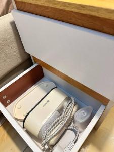 a drawer with a cell phone in it at Luxy Stay Gensan in Lagao II