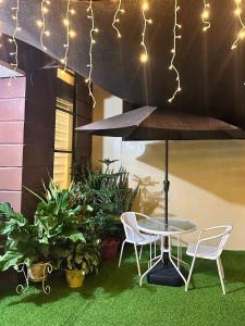 a patio with a table and chairs and lights at Luxy Stay Gensan in Lagao II
