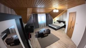 an overhead view of a living room with a bed and couch at Casa Adriana in Băile Herculane +41 photos