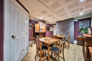 a dining room with a wooden table and chairs at Art House in Derry Londonderry