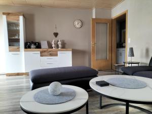 a living room with two tables and a couch at Ferienwohnung Naturblick in Schönhagen