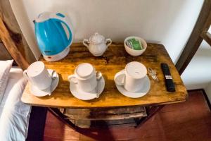 a table with cups and dishes on top of it at Cusco'sHome 3 in Cusco