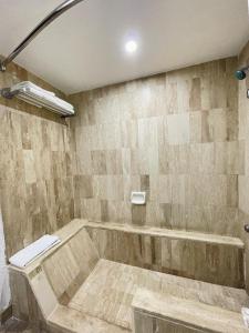 a bathroom with a tub with a toilet in it at Hotel Arroyo de la Plata in Zacatecas +11 photos