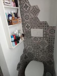 a bathroom with a toilet and a tile floor at La Petite Maison in Campagnatico +4 photos