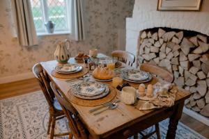 a wooden table with food and eggs on it at Master Builder's House Hotel in Beaulieu