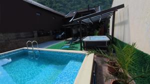 a swimming pool in front of a house at Casa Adriana in Băile Herculane