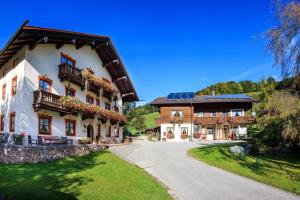 a large building with flowers on the balconies on it at Oberaschenauer-Hof inkl. Chiemgaukarte in Ruhpolding