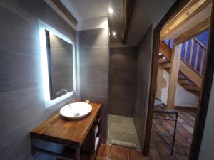 a bathroom with a sink and a mirror at L'Oustalou in Rosières +57 photos