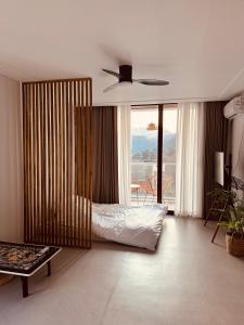 a bedroom with a bed and a ceiling fan at Radiance Stay in Paengnodam +80 photos