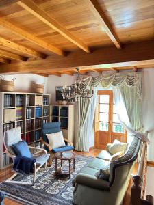 a living room with a couch and chairs and a chandelier at Casa Conchas in Ferreira