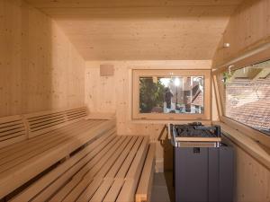 an empty sauna with a stove and a window at Saunaloft Schwarzwald - privater 45qm Saunabereich - großzügige Räume mit viel Ruhe in Gemeinde Aichhalden
