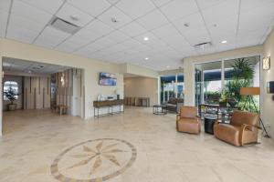 an office lobby with chairs and tables and windows at Apollo 207 in Marco Island +58 photos