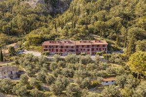 an aerial view of a building in a forest at Mont&Lac Lake View Apartment in Limone in Limone sul Garda