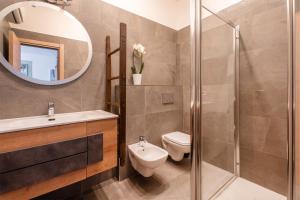 a bathroom with a sink toilet and a mirror at Mont&Lac Lake View Apartment in Limone in Limone sul Garda +10 photos
