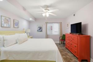 a bedroom with a bed and a tv on a dresser at SeaSpray West 303-Gulf Front in Perdido Key