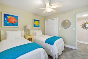 a bedroom with two beds and a ceiling fan at SeaSpray West 303-Gulf Front in Perdido Key +34 photos