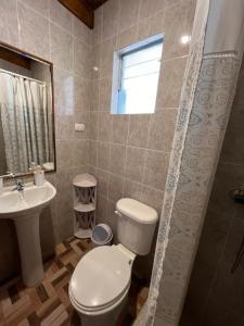 a bathroom with a toilet and a sink at Hostal Piedrita de Rio in San Pedro de Atacama +33 photos