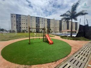 a playground in a park with a swing at Apartamento Ricaurte in Ricaurte