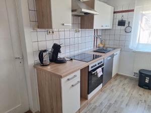 a small kitchen with a counter and a stove at Delblaiso Suite in Memmingen