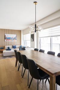 a dining room with a large wooden table and chairs at Unité 104 in Beaupré