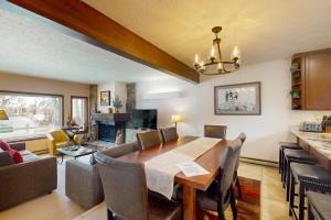 a dining room and living room with a table and chairs at Teton Shadows Darwin F in Jackson
