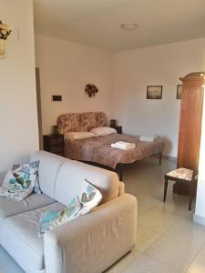 a living room with a couch and a bed at Salina in Trappeto