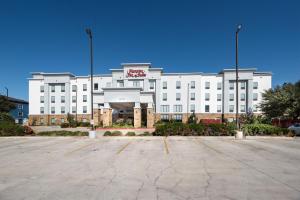 a white building with a parking lot in front of it at Hampton Inn & Suites New Braunfels in New Braunfels