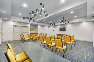 a conference room with yellow chairs and a podium at Hampton Inn & Suites New Braunfels in New Braunfels