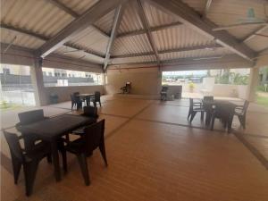 a large room with tables and chairs in a building at Apartamento Ricaurte in Ricaurte