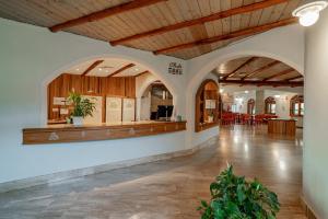 a lobby with arches and a counter in a building at Club Esse Posada in Palau +58 photos