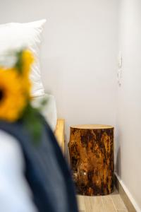 a tree stump in the corner of a room with a pillow at MNS Accommodations in Salamina